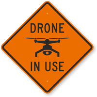 an orange sign that says drone in use