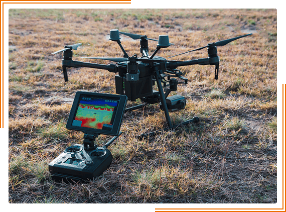 a remote controlled flying device in the middle of a field