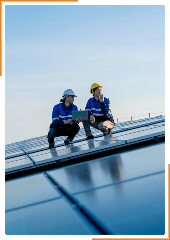 two workers on top of a solar panel