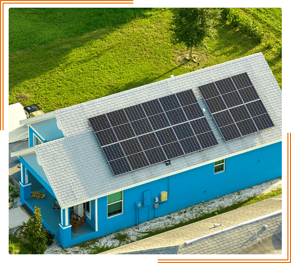 an aerial view of a blue house with a solar panel on the roof