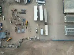 Overhead drone view of a construction yard with trailers and equipment