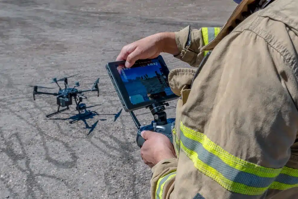 Case Studies on Drone Usage in Inspections: Drone Inspections Use Cases 11 Firefighter flying an inspection drone with a tablet controller